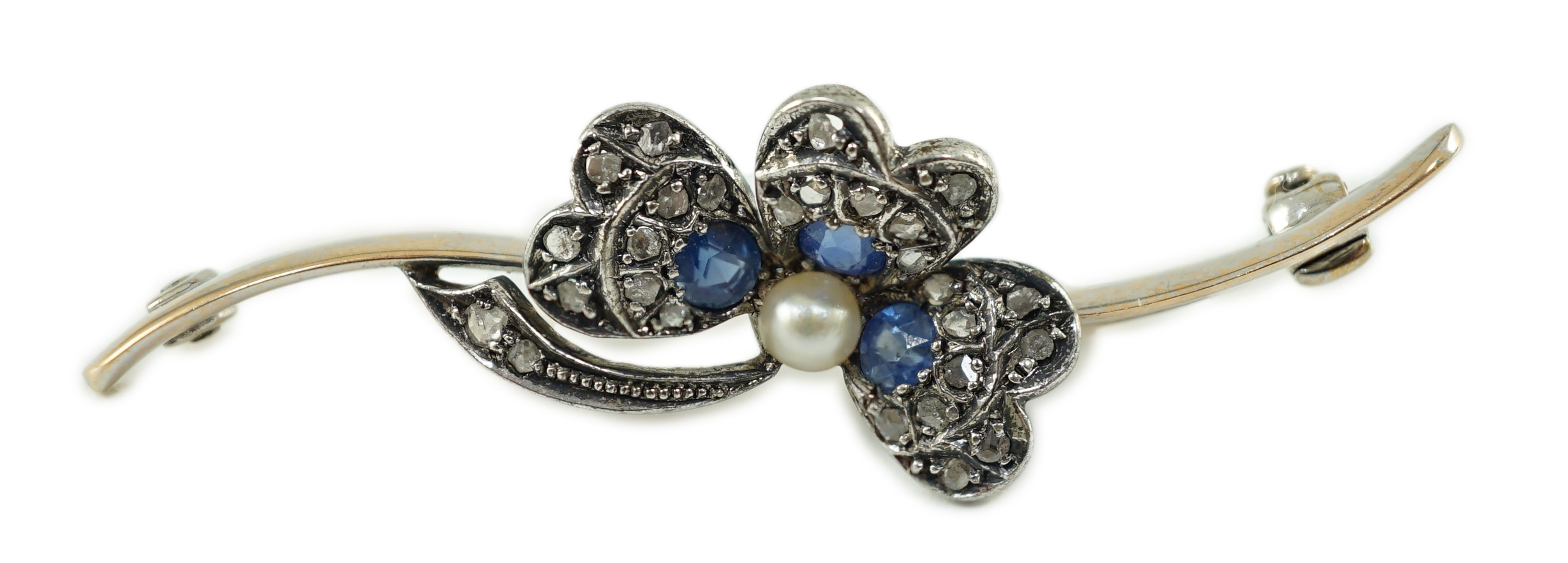 A 1920’s white gold, sapphire, cultured pearl and rose cut diamond set shamrock bar brooch